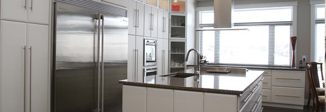 image of kitchen with white cabinets and black countertops